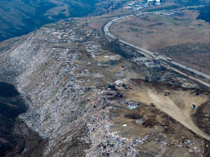 На объездной дороге Тбилиси огромная свалка мусора, части которой разлетаются по соседним склонам